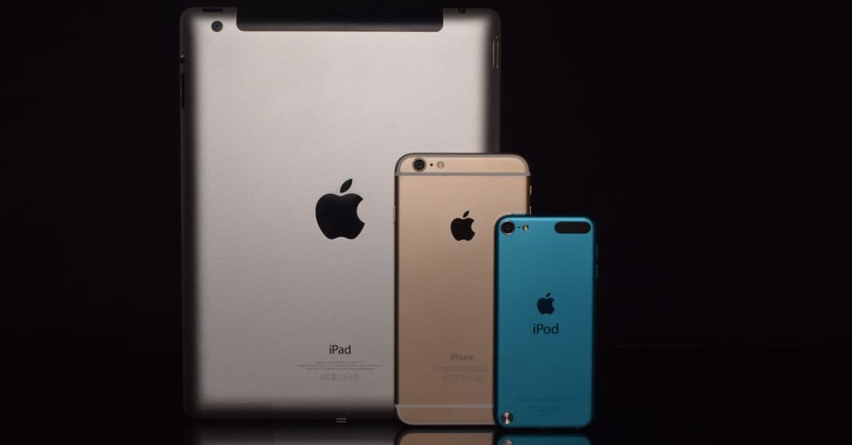 Elegant display of Apple devices including iPad, iPhone, and iPod against a black background.