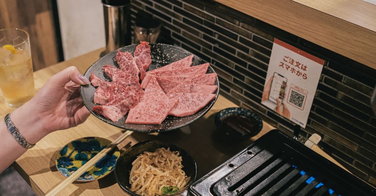 Close-up of premium Wagyu beef slices prepared for a Japanese BBQ experience.
